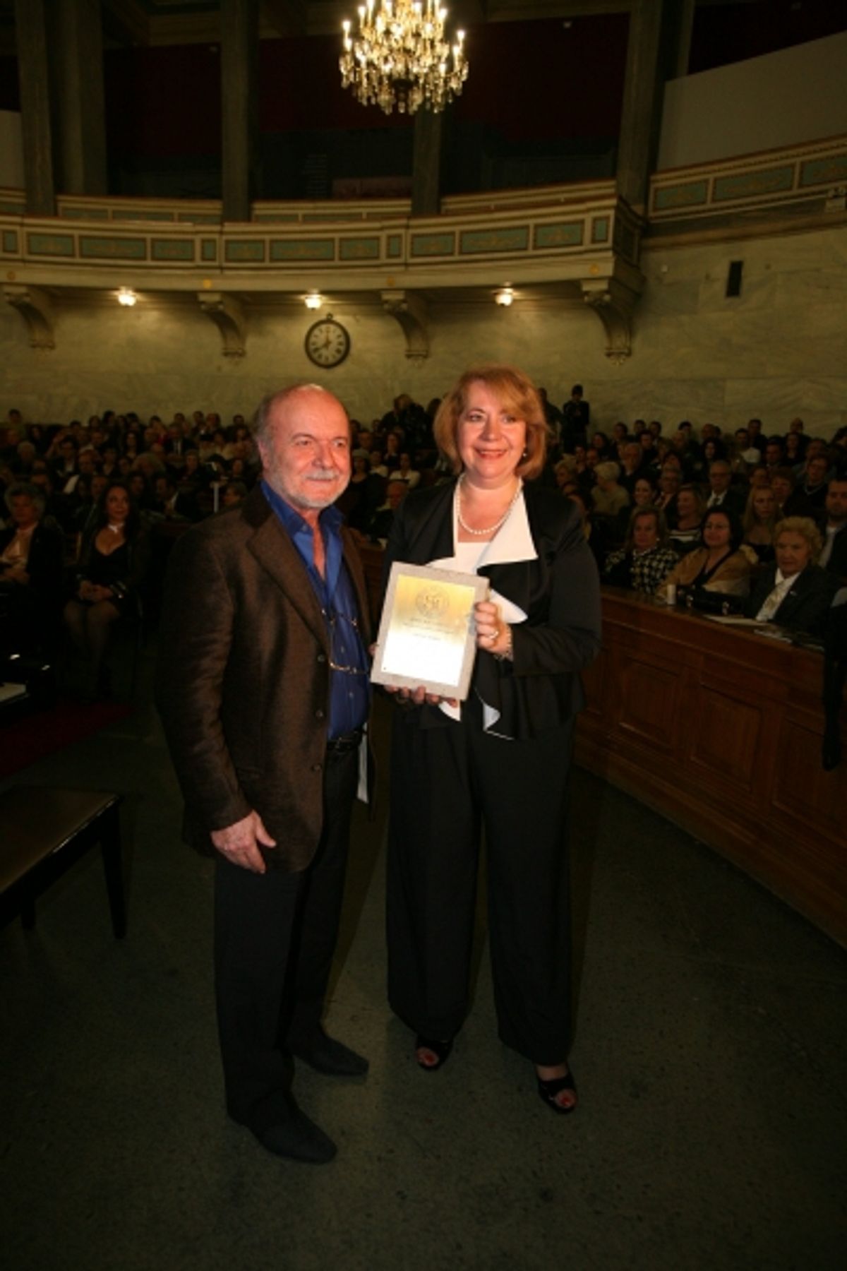 Dora Ziongas, Vice President of George 'Best' Costacos Cultural and Cancer Research Foundation USA presenting George Best Costacos Award for contributions to art and culture awarded to world-renown composer Mikis Theodorakis at George Costacos Award Gets Presented to Ms. Marianna Vardinogianni