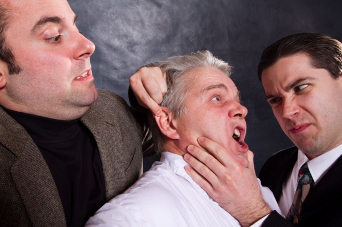 Sporty (Anthony Tournis), and the Commissioner (Eric Paskey) interrogate Bertozzzo (Vincent Lonergan, center) at 