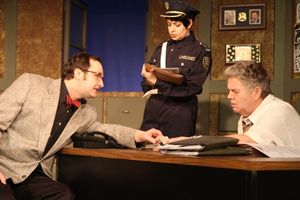 The Madman (Joseph Stearns, left) explains himself to Officer #1 (Elizabeth Bagby, ce Photo