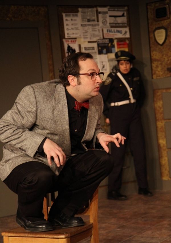 The Madman (Joseph Stearns, left) shocks Officer #1 (Elizabeth Bagby, right) with his Photo