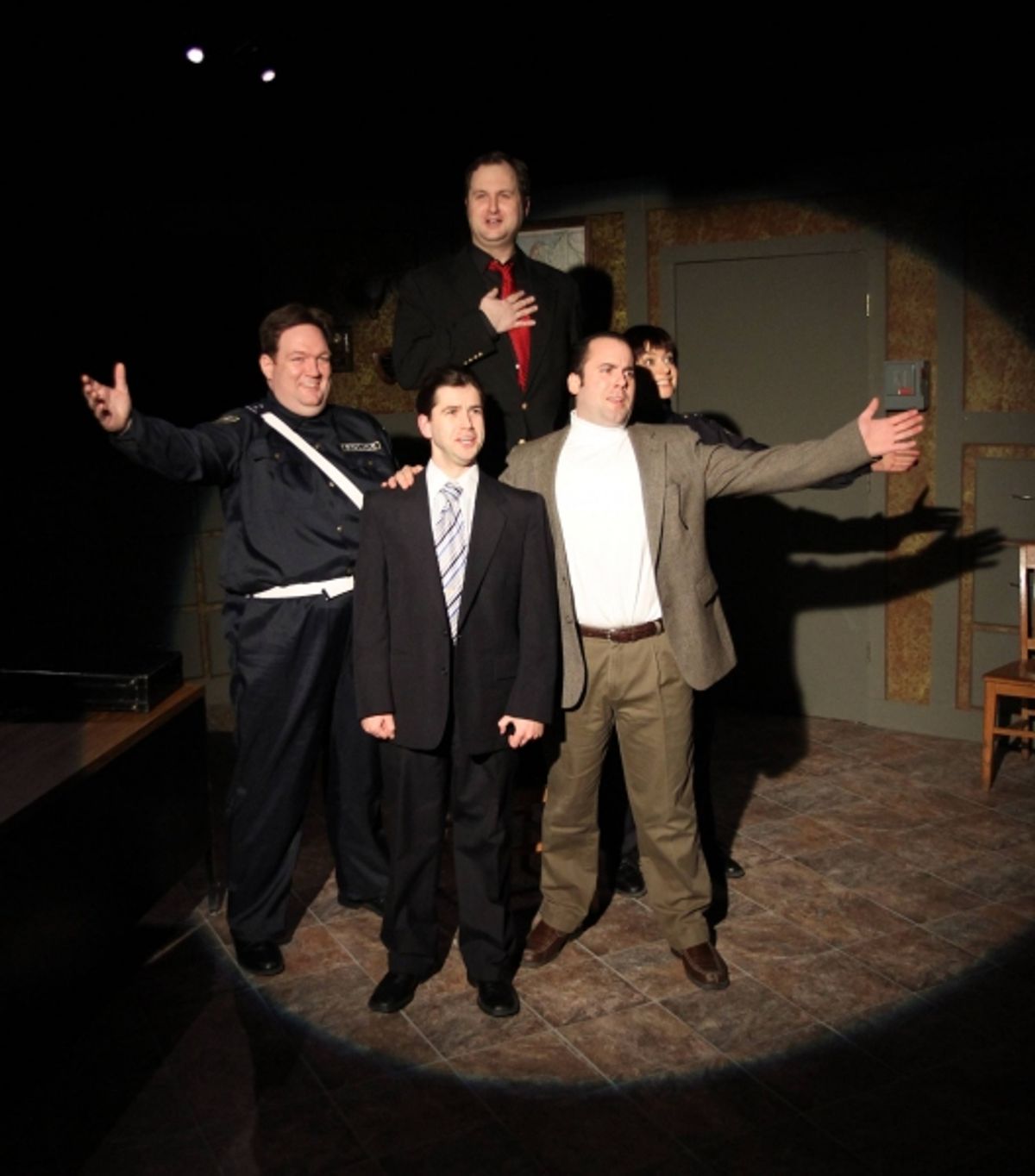 Officer #2 (Christopher M. Walsh, left), the Commissioner (Eric Paskey, center front), the Madman (Joseph Sterns, back, red tie), Sporty (Anthony Tournis, right, white shirt), and Officer #1 (Elizabeth Bagby, back right) sing a song together at 