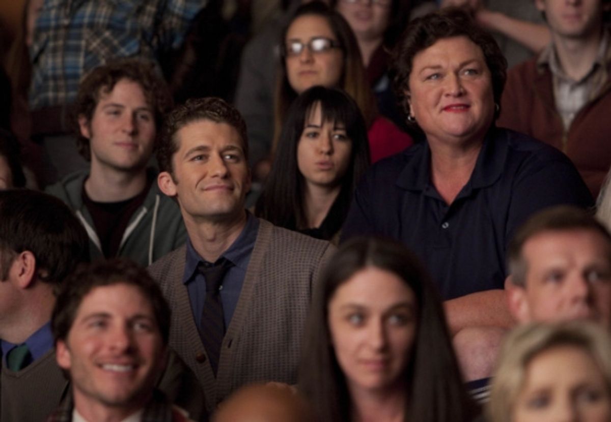 Will (Matthew Morrison, L) and Coach Beiste (guest star Dot-Marie Jones, R) watch the glee club perform. at 