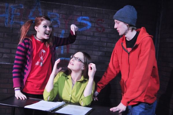Shane Tarplee (sitting) as Peck and Abby Hart (on floor) as Dora Photo
