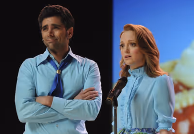 Carl (guest star John Stamos, L) and Emma (Jayma Mays) Photo