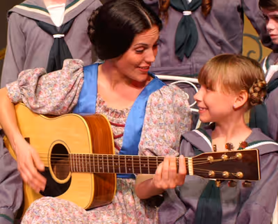 Maria (Micah Richerand Desnoier) shares a tender moment with Gretl (Bevin Kelley) Photo