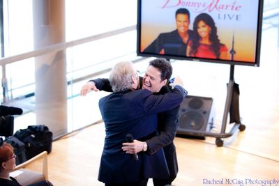 Donny Osmond embraces Colm Wilkinson Photo
