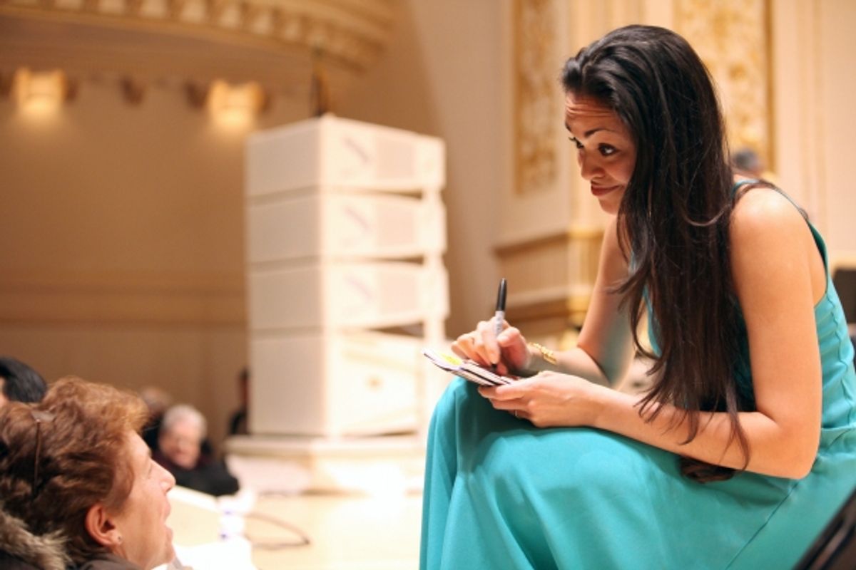 Karen Olivo signs an autograph at the  Open Rehearsal and Concert Performance of The New York PopsÃ�'â€¢ The Great Judy Garland Ã�'Â a one-night-only, song-for-song recreation of GarlandÃ�'â€¢s historic 1961 performance at Carnegie Hall in New York City. at 