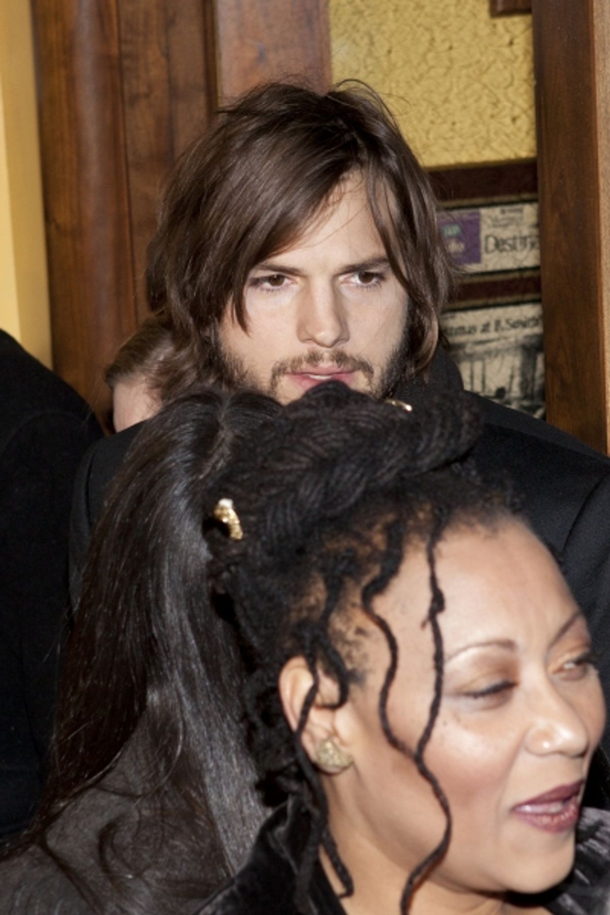 Ashton Kutcher breezing past the press line and Fredi Walker-Browne at 
