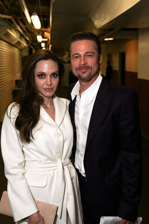 LOS ANGELES, CA - APRIL 13: Actors Angelina Jolie (L) and Brad Pitt (R) pose backstag Photo