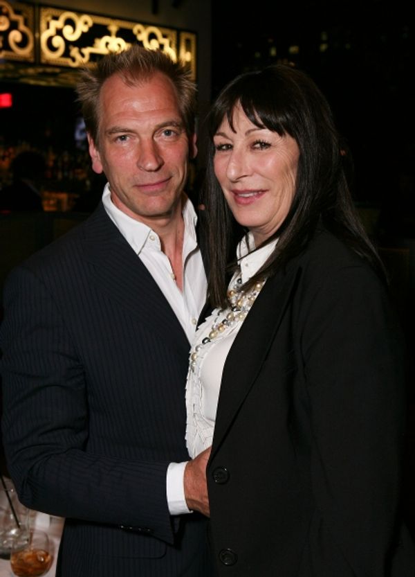 LOS ANGELES, CA - APRIL 13: Julian Sands (L) and actress Anjelica Huston (R) pose at  Photo