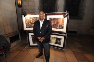 Set designer and artist Bryan Collier posing with his work Photo