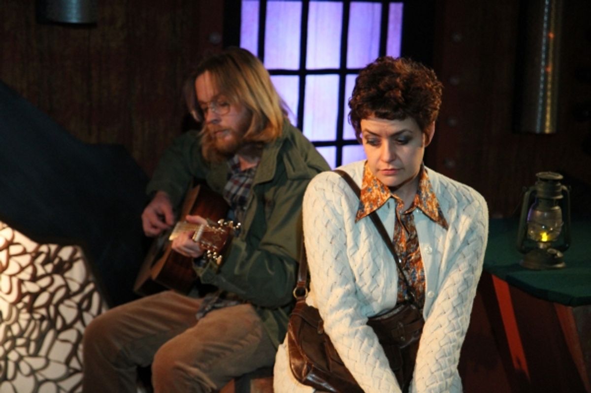 Garret (Aaron Snook) plays the guitar for Linda (Elizabeth Bagby) at 
