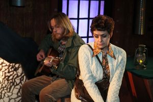 Garret (Aaron Snook) plays the guitar for Linda (Elizabeth Bagby) Photo