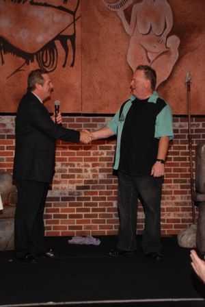 HarrahÃ¢â‚¬â„¢s President Rick Mazer congratulating Caveman star Kevin Burk Photo