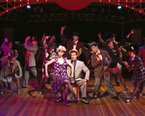 Charlotte Fox as Roxie Hart and Kerby Thompson as Billy Flynn with the cast of "CHICA Photo