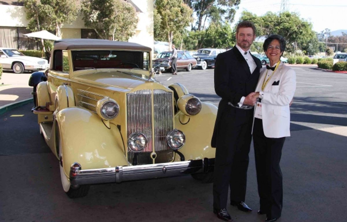 Legends Host, B. Harlan Boll, and event chair, Carmi Standish, pose with a 1938 Packard 12 Convertible Coupe at 