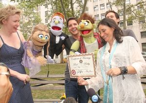 The official marriage certificate is presented to the puppets by Amy Hausman of the S Photo