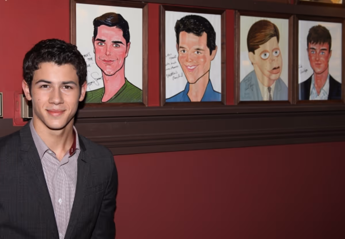 Nick Jonas announces he will star in the Broadway Musical 'How To Succeed in Business without Really Trying' starting January 24, 2012 at the Al Hirschfeld Theatre in New York City.. Seen here with Portraits of past actors who has starred in his role. at 