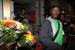 Samuel L. Jackson receives flowers from a fan Photo