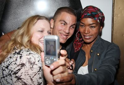 Angela Bassett poses with fans Photo