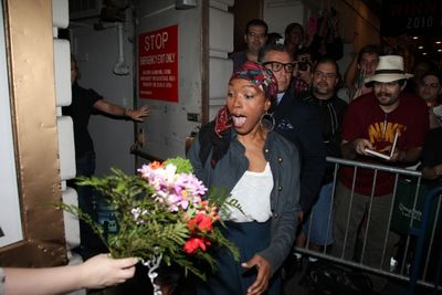 Angela Bassett receives flowers from a fan Photo