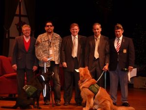 Members of East Coast Assistance Dogs accept donation check from Owners Bob Funking a Photo