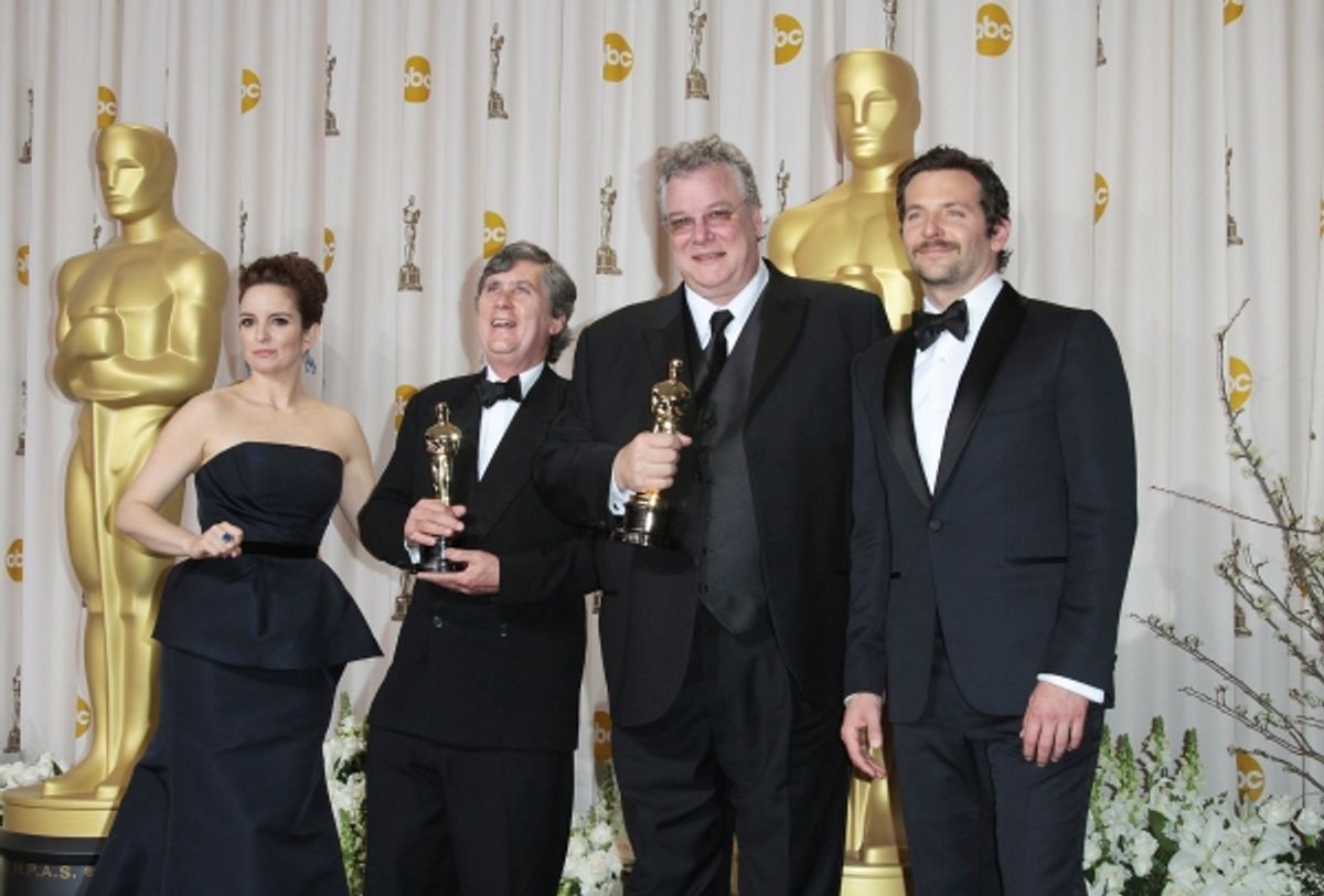 Tina Fey and actor Bradley Cooper pose with Eugene Gearty (second from left) and Philip Stockton (second from right), winners of the Sound Editing Award for 'Hugo' at 