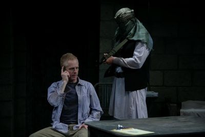 John Hickok as Nick and Michael James Reed as the guard Photo