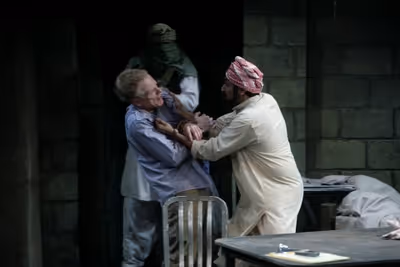 Michael James Reed as the guard, John Hickok as Nick and Bhavesh Patel as Bashir Photo