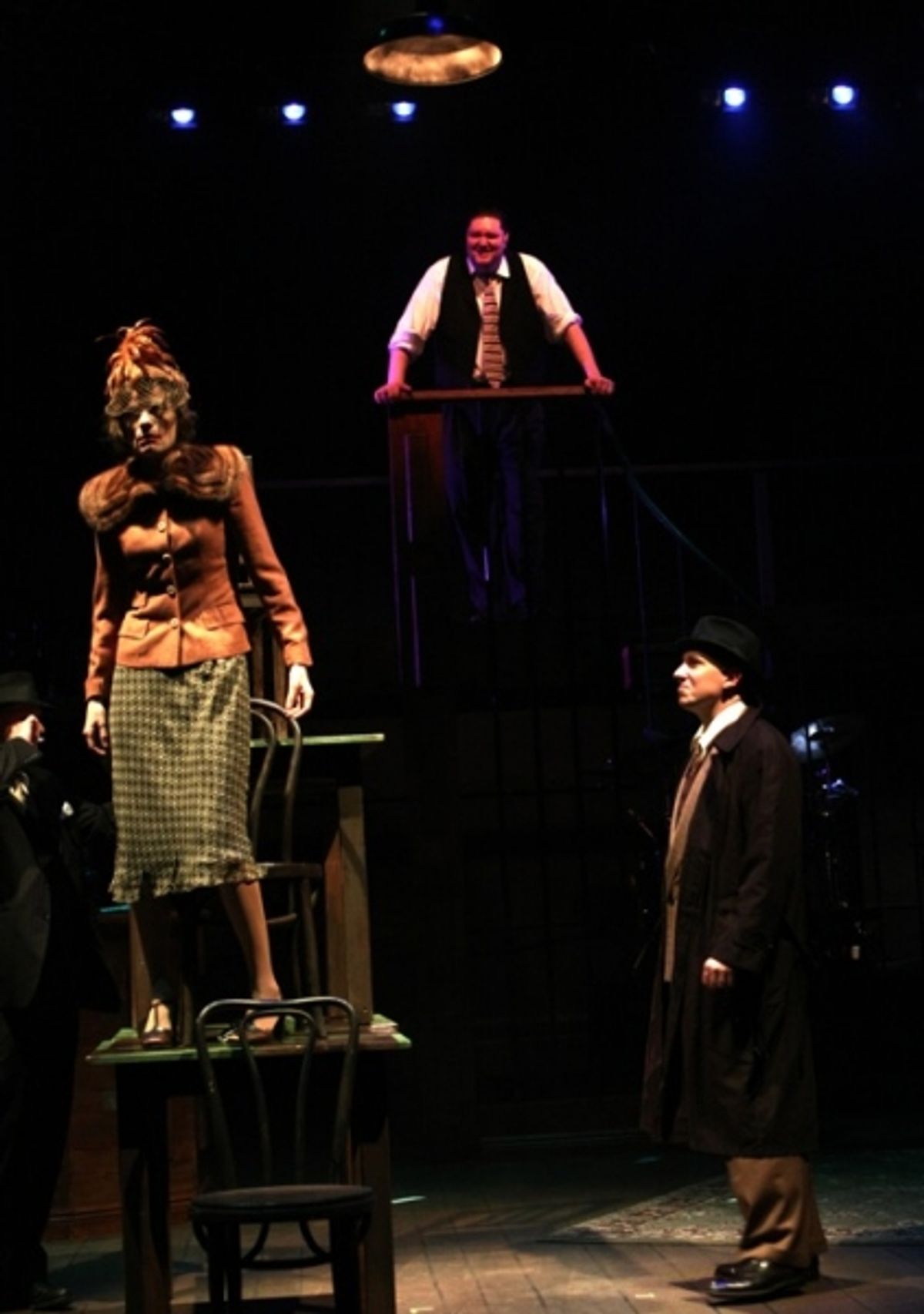 J. Edgar Hoover (E.J. Subkoviak, top) interrogates Paula Harmon (Kimberly Richardson) with the help of his G-men (Eric Knutson & Jake Endres). at 