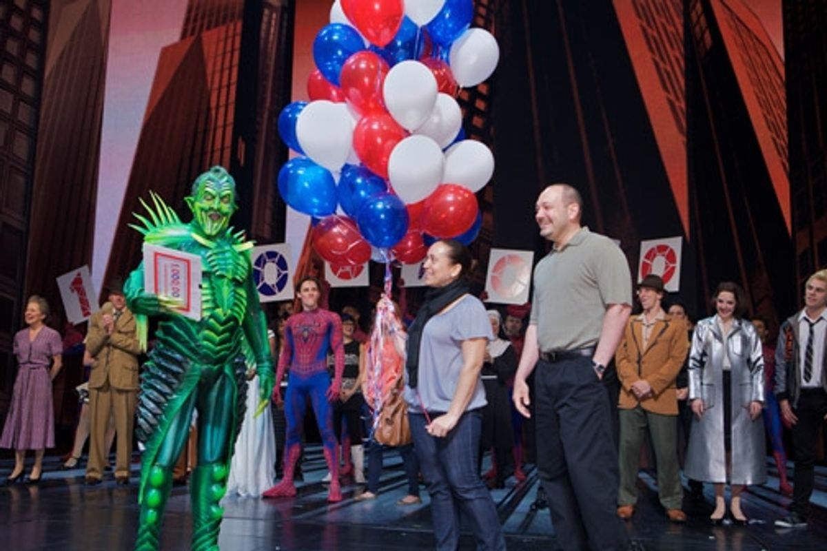 Patrick Page presents a VIP package to 1 millionth audience member Yvelisse Fermin and Alex Hellinger at 