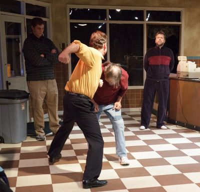 Bill Svelmoe punches Gary Oesch; Joseph Goepfrich and David Chudzynski look on Photo