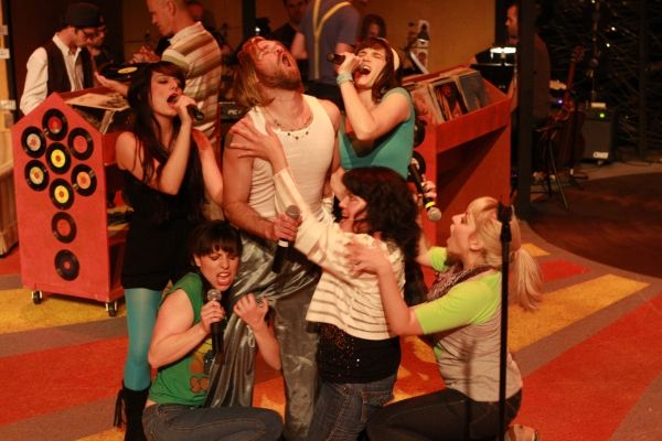 Laura (Kimi Short, center) and the Ex-Girlfriends surround Ian (Aaron Allen) Photo