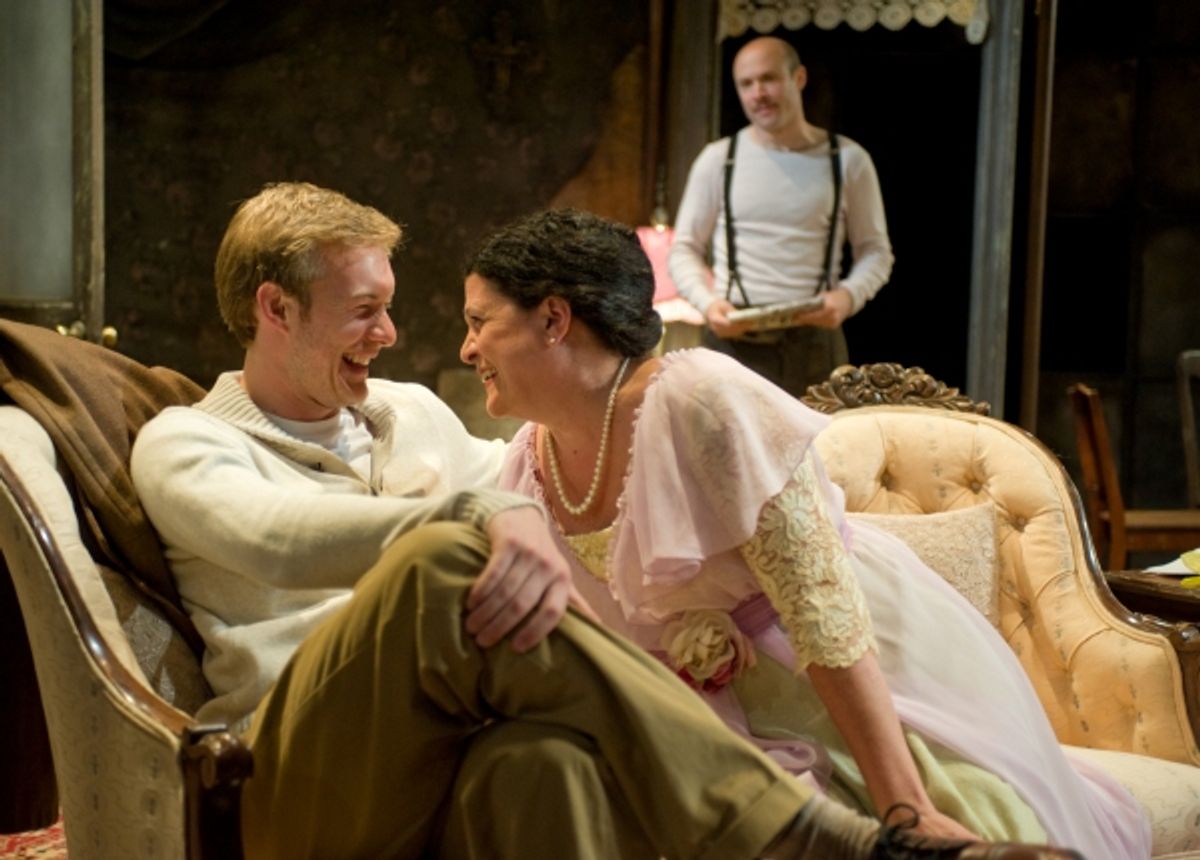 The gentleman caller Jim O'Connor (Brett Schneider) charms Amanda (Kathy Scambiatterra) as Tom (Aaron Roman Weiner) looks on  at 