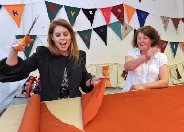 HRH Princess Beatrice successfully tries her hand at pattern cutting as she scissors  Photo