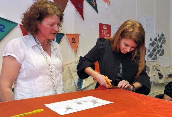 Steady as she goes. HRH Princess Beatrice tries her hand at pattern cutting as she sc Photo