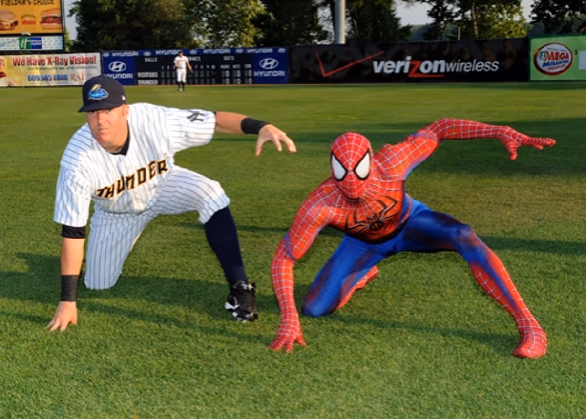 Spider-Man and Trenton Thunder player Luke Murton strike a Spidey pose at SPIDER-MAN Throws First Pitch for Trenton Thunder