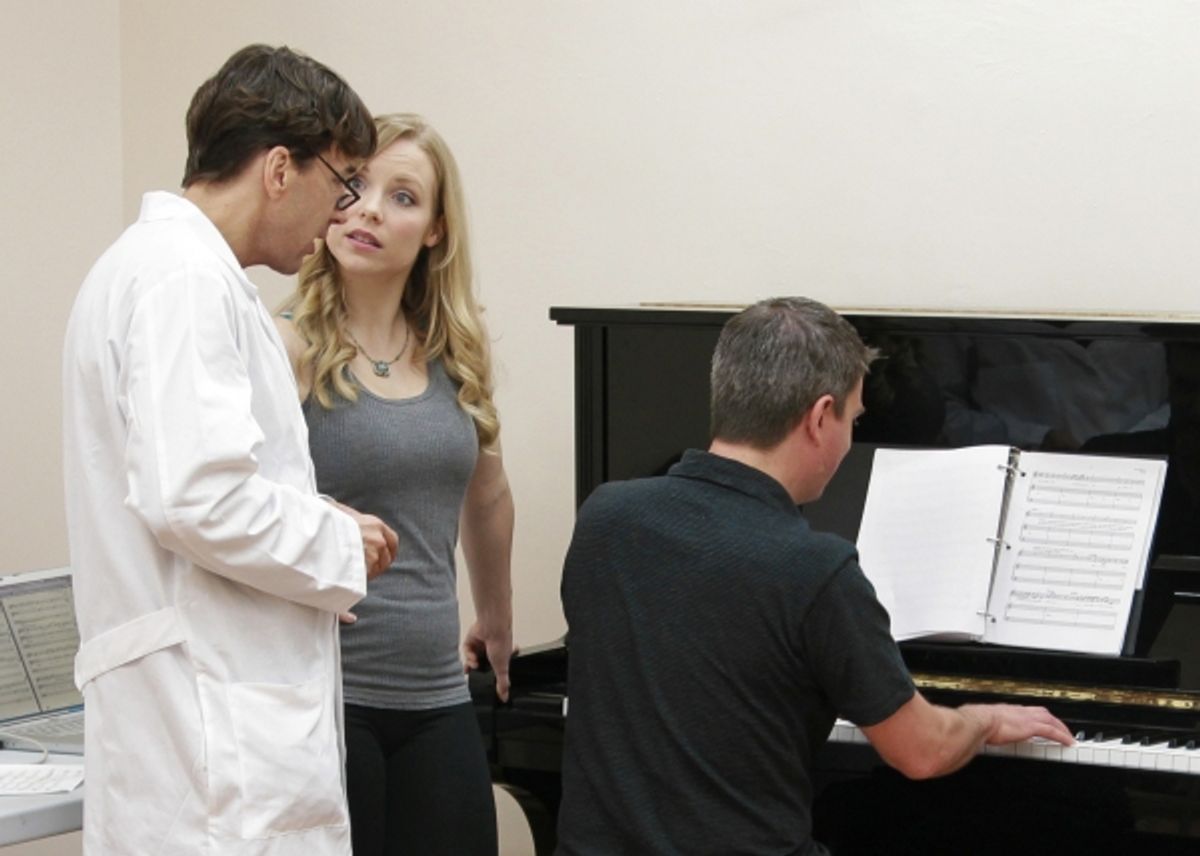 Michael Andrew and Marissa McGowan rehearse a song at the piano with help from conductor Stephen Kummer. at 